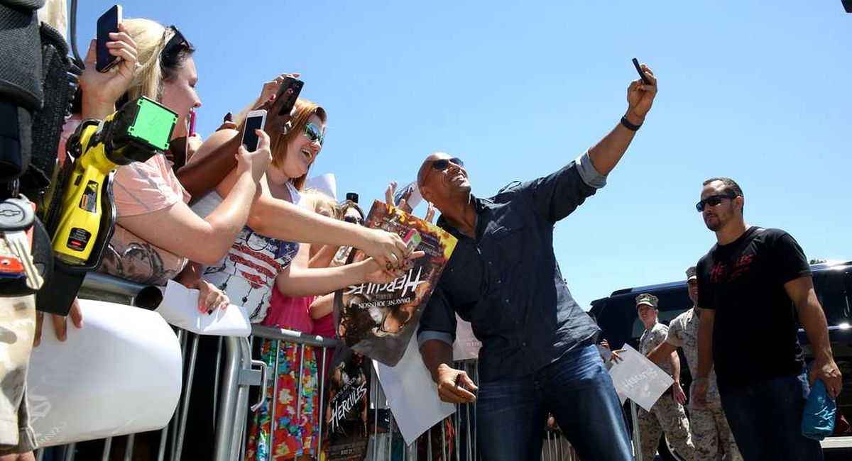Actor Dwayne "The Rock" Johnson takes selfies with fans | Public Domain Dedication